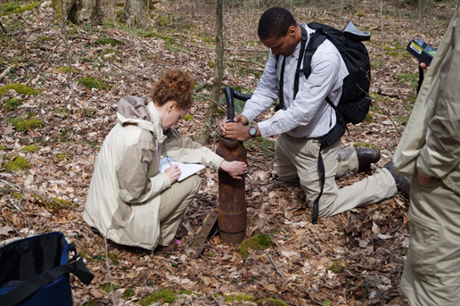 Drs. Natalie Pekney and Dennis Donaldson shown measuring emissions of methane from an abandoned, unplugged oil well in Oil Creek State Park, Pennsylvania. The well had been located using aerial magnetic surveying techniques developed at NETL RIC.