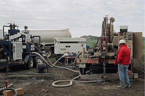 LANL microdrilling at the RMOTC-operated Teapot Dome Field at NPR. No. 3.  The microdrilling rig includes the coiled tubing drilling unit on the right, mud cleaning system on the left, and the RMOTC drilling water truck in the center.