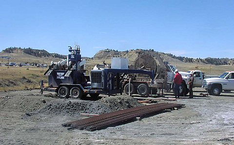 Microdrilling site at the Naval Petroleum Reserve No. 3. The Los Alamos drilling mud cleaning system (left) and coiled tubing drilling rig (right) are shown.