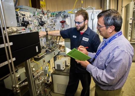 NETL researchers John Johnson and Dushyant Shekhawat operate a state-of-the-art variable frequency microwave reactor in  the Reaction Analysis and Chemical Transformation (ReACT) facility