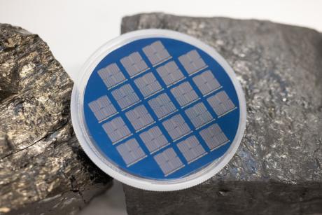 A 3-inch wafer with over 15,000 field effect transistors fabricated with carbon material derived from coal.