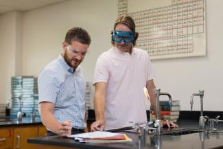 NETL researcher Scott Crawford, left, discusses STEM-related activities with Justin Sickles, a chemistry teacher at West Mifflin Area High School.